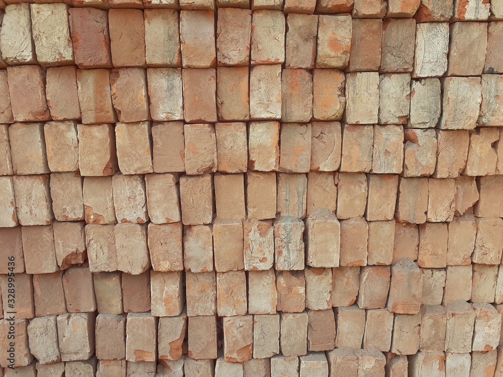 Rows of orange colour bricks laid on each other. Bricks pattern background Rows of orange colour bricks laid on each other. Bricks pattern background