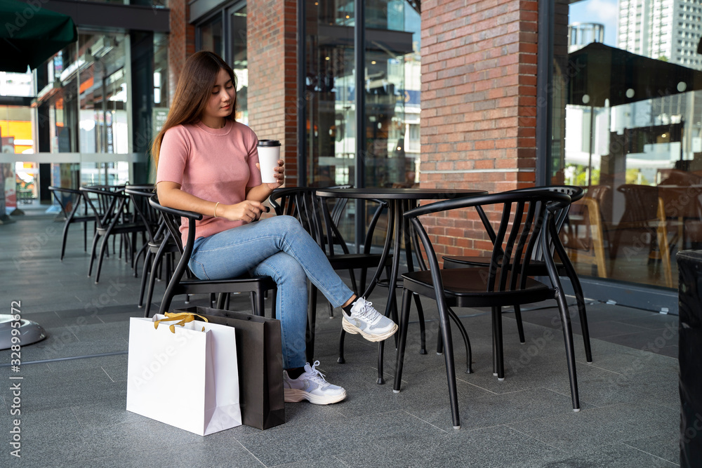 Young pretty woman and blank screen on shopping bag mock up design Young pretty woman and blank screen on shopping bag mock up design
