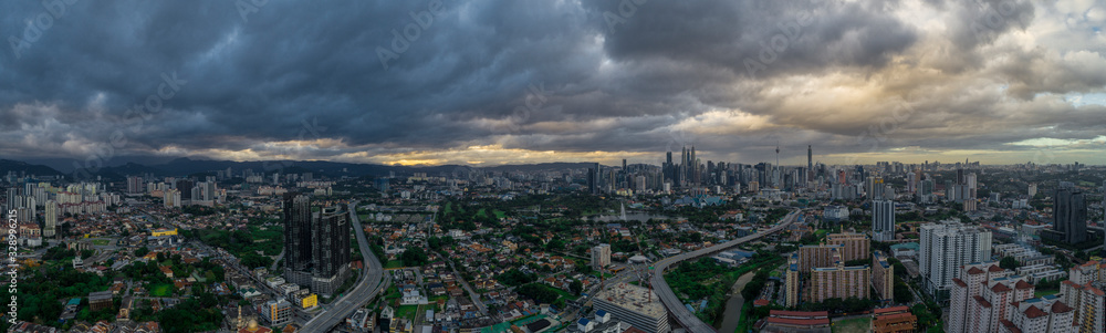 Aerial Panoramic view of Kuala Lumpur with rain clouds during day time.