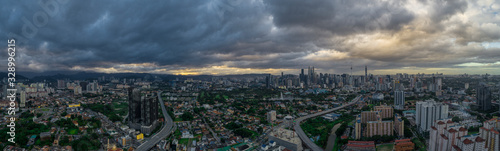 Aerial Panoramic view of Kuala Lumpur with rain clouds during day time.