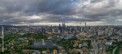 Aerial Panoramic view of Kuala Lumpur with rain clouds during day time.