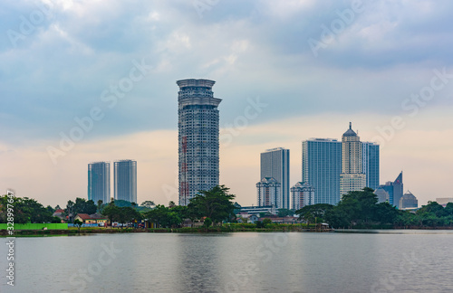 Tangerang, Indonesia - 5th January 2018: A view of Kelapa Dua Lake in the foreground and Lippo Karawaci district buildings in the background. Taken in a cloudy afternoon. Property investment. © HaniSantosa