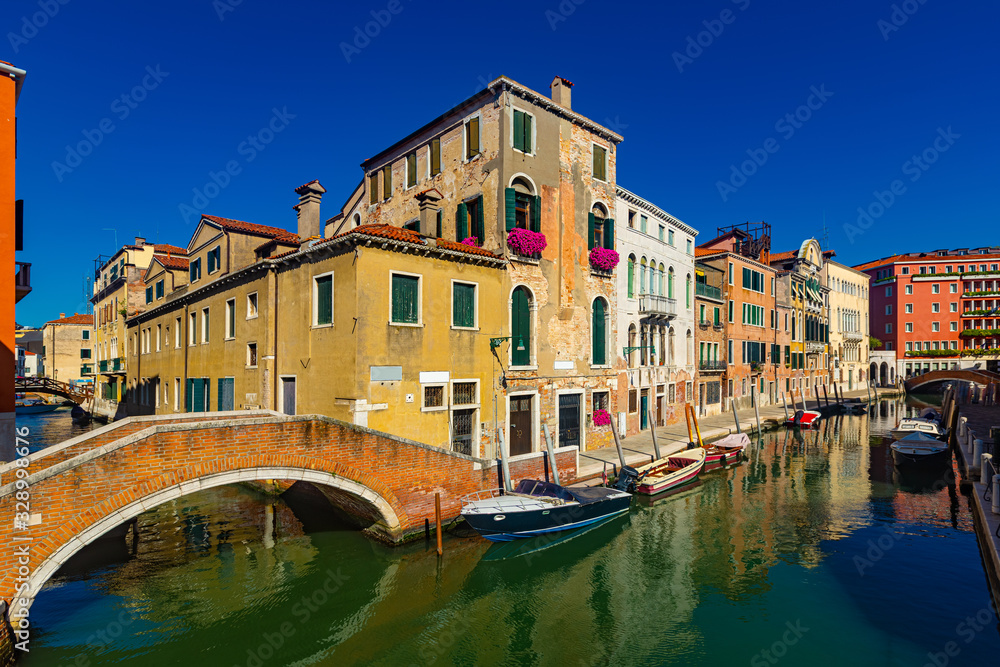 View of  canals and cityscape with colorful buildings in Venice