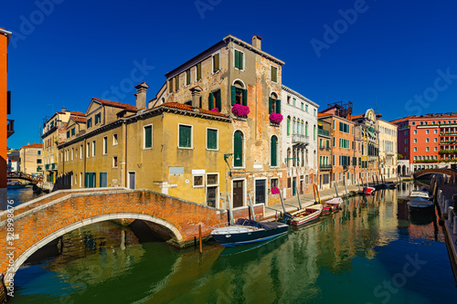 View of canals and cityscape with colorful buildings in Venice