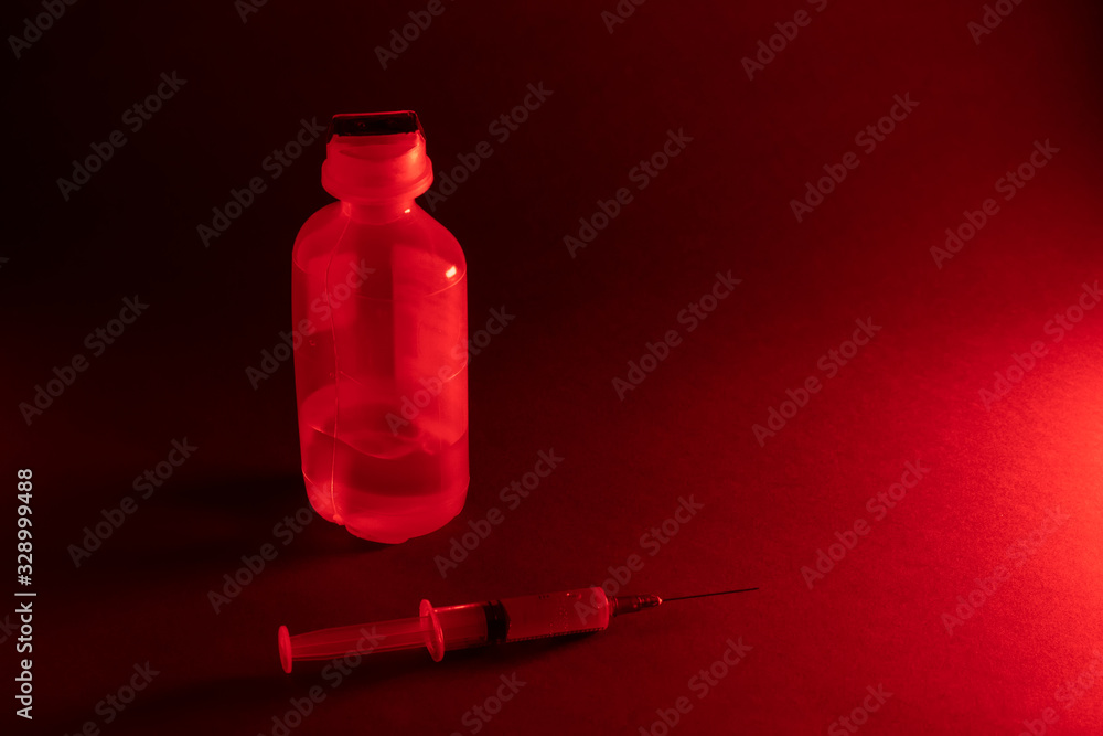 Syringe for injection and medicine in a transparent container on a gray background. Copy space Syringe for injection and medicine in a transparent container on a gray background. Copy space