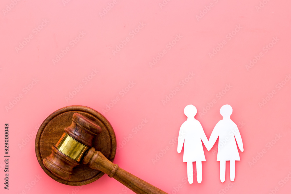 Discrimination concept. Judge gavel, female couple on pink background top-down copy space Discrimination concept. Judge gavel, female couple on pink background top-down copy space