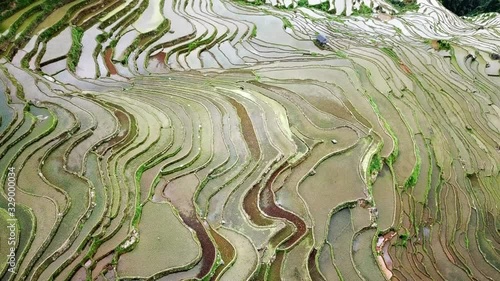 Jiabang terraced fields in Guizhou of China; A high-angle shot of terraced fields filled with water in the rice planting season photo