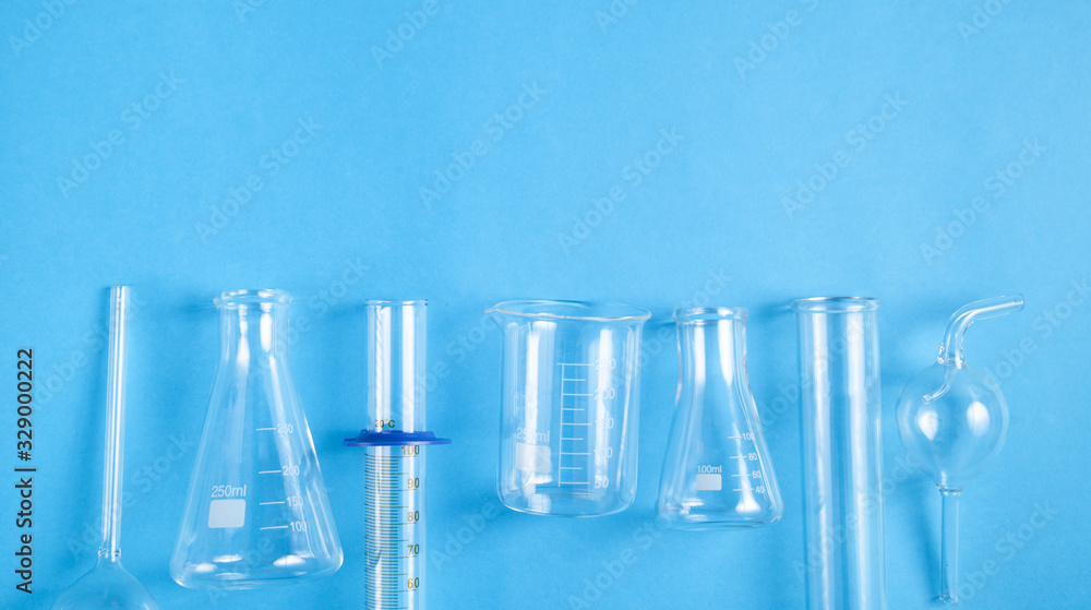 Fototapeta Science glass flasks on blue background.