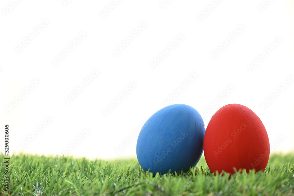 blue and red easter egg on lawn green grass artificial with blank white background