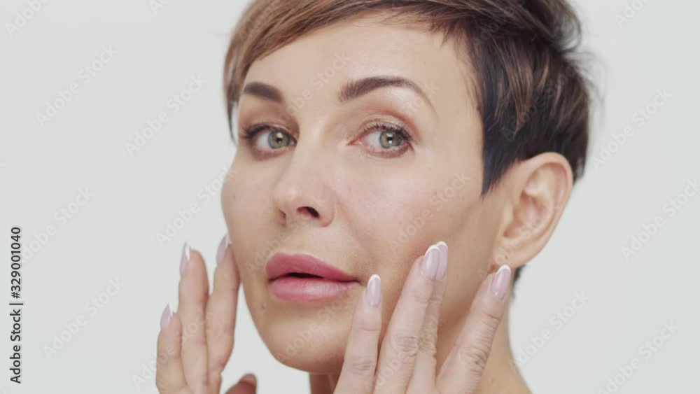 Close-up of middle aged mature woman over white bacjground. Portrait of mature lady. Plastic surgery, beauty injections and cosmetology. Close-up of middle aged mature woman over white bacjground. Portrait of mature lady. Plastic surgery, beauty injections and cosmetology.