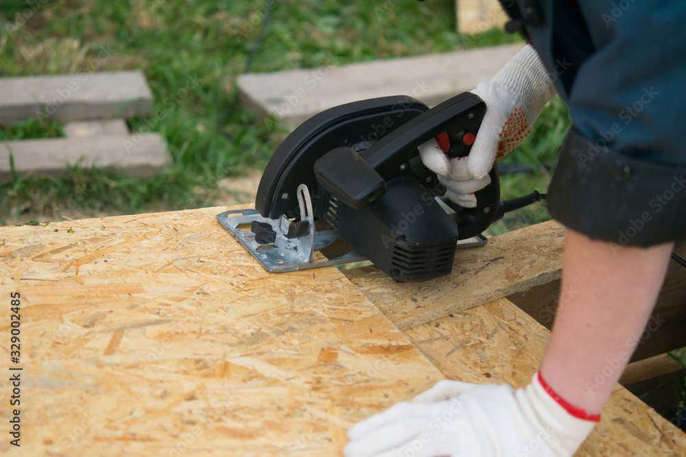 close-up, cutting a wooden Board with an electric saw
