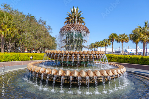 Pineapple Fountain at the Waterfront Park in Charleston, South Carolina, USA on February, 2020 with tree and bridge in background. The Pineapple Fountain is a focal point in the park. 