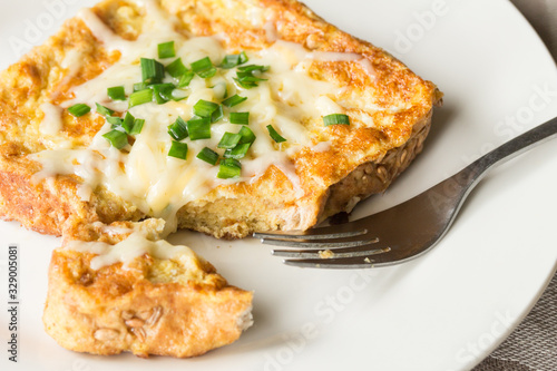 French toast with cheese and chives on white plate