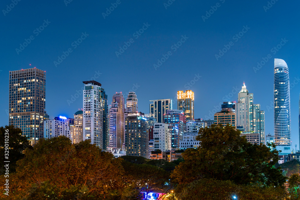 Cityscape of picturesque Bangkok at night time from rooftop. Panoramic evening skyline of the capital city of Thailand. The concept of metropolis.