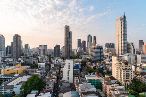 Aerial cityscape of picturesque Bangkok at sunset from rooftop view. Panoramic sunrise skyline of the biggest city in Thailand. The concept of metropolis.