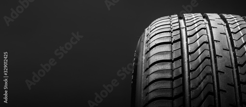 a black isolation rubber tire, on the black backgrounds photo