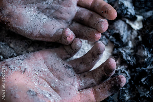 burnt ash in the hands of a teenager close -up