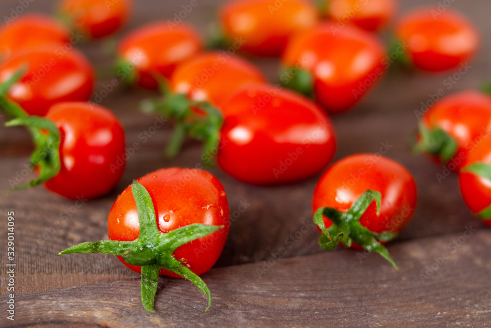 Fresh, ripe cherry tomatoes on wooden board. Fresh, ripe cherry tomatoes on wooden board.