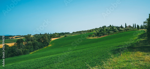 Beautiful view in Tuscany, Italy. Rural landscape. Countryside hills and meadows, green and yellow fields and sky. Beautiful world.