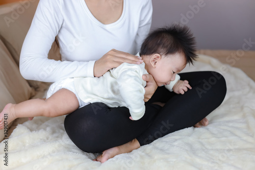 Quadro su tela Infant baby boy belching after drink breast milk by mother