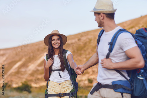 Hiking couple with backpack walking on hike in nature