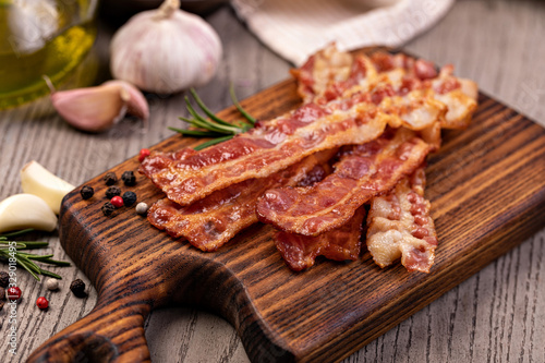 Closeup of slices of crispy hot fried bacon photo