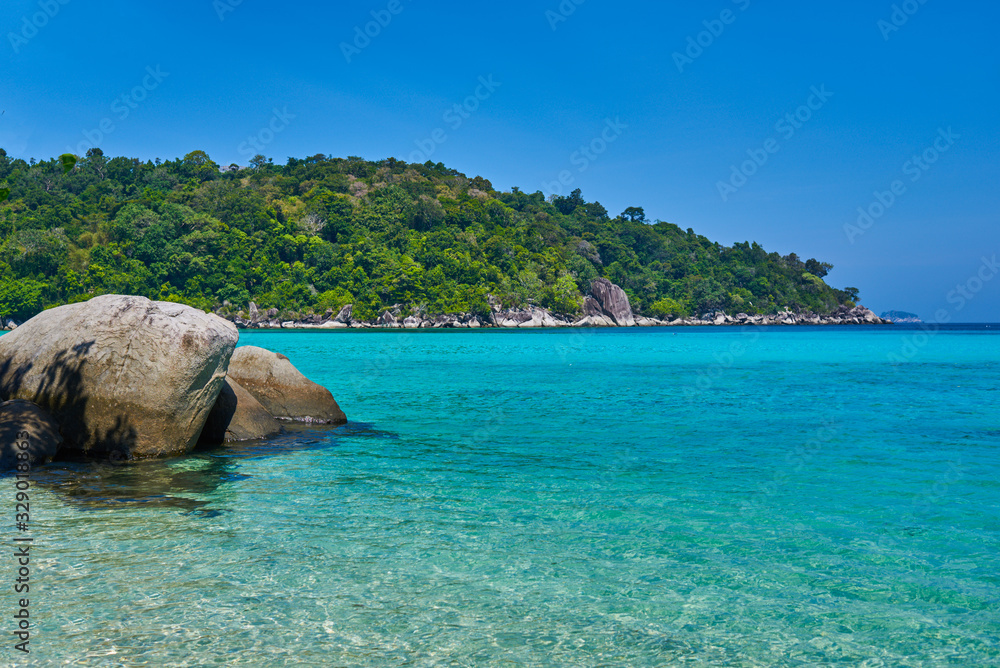 Fototapeta premium Tropical paradise beach with white sand and blue sky turquoise water and granite rocks travel tourism background concept. Amazing tropical holidays in paradise beaches of Tioman island, Malaysia.