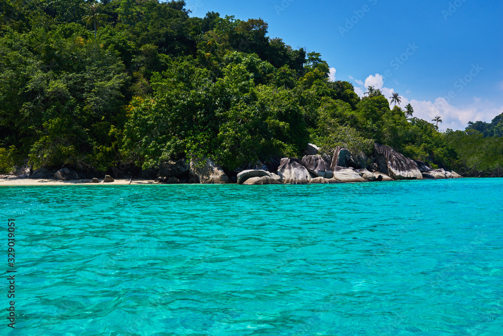 Obraz premium Turquoise sea, rain forest, rocks, ocean. Exploring tropical paradise island. Perfect getaway. Relaxing. Travel concept and idea. Beautiful azure ocean.