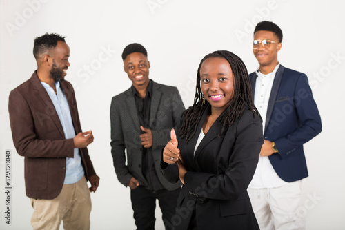 team of young african people in suits on a white background with phones in their hands