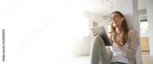 Template woman at home relaxing and websurfing with digital tablet