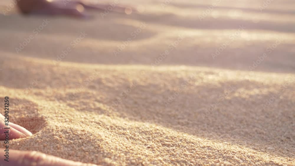 SLOW MOTION Gimbal shot of a woman's hands in the sand while practicing yoga. Closeup shot with hand and sand detail. Sunset in desert. SLOW MOTION Gimbal shot of a woman's hands in the sand while practicing yoga. Closeup shot with hand and sand detail. Sunset in desert.