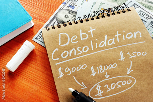 Debt consolidation title with written calculations. photo