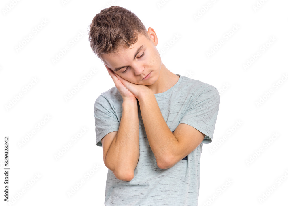 Portrait of teen boy sleeping tired or dreaming posing with hands together while smiling with closed eyes. Cute young caucasian teenager isolated on white background. Happy child. Portrait of teen boy sleeping tired or dreaming posing with hands together while smiling with closed eyes. Cute young caucasian teenager isolated on white background. Happy child.