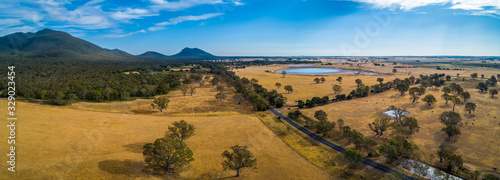 Victoria Valley Road passing through grasslands towards mountains in Australia