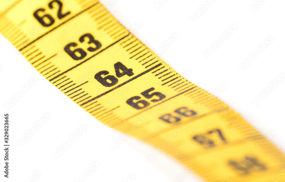 Close-up of a yellow measuring tape isolated on white - 64 Close-up of a yellow measuring tape isolated on white - 64