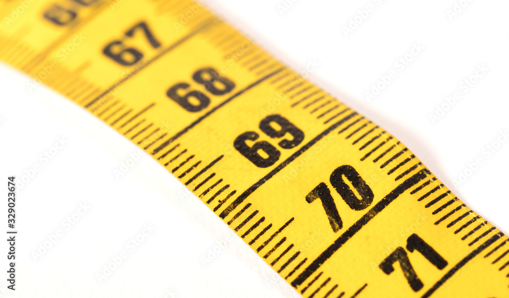 Close-up of a yellow measuring tape isolated on white - 70 Close-up of a yellow measuring tape isolated on white - 70