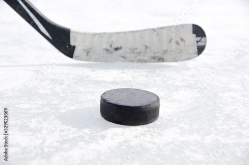 ice hockey stick with black tape and puck