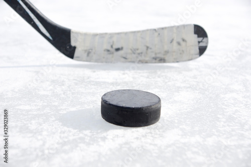 Photography ice hockey stick with black tape and puck
