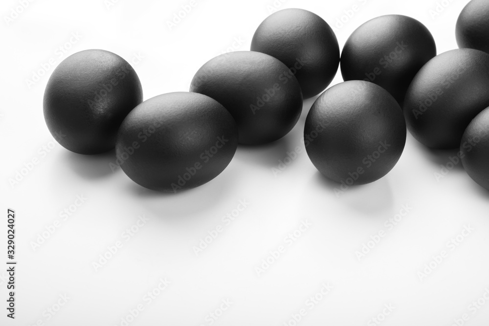 Composition of black easter eggs on a white background. Easter minimalistic concept Composition of black easter eggs on a white background. Easter minimalistic concept
