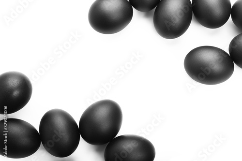 Composition of black easter eggs on a white background. Easter minimalistic concept
