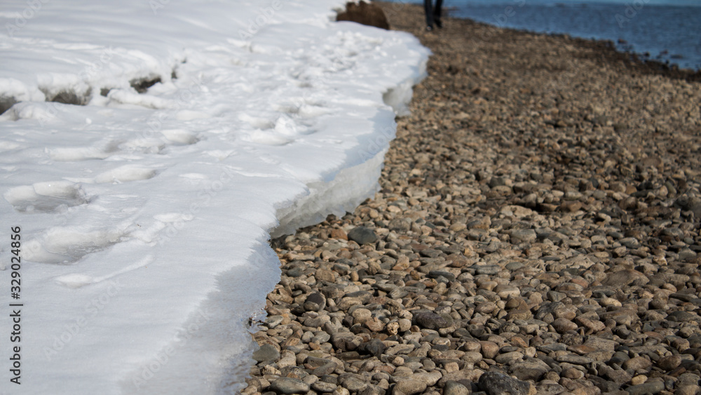 Snow and stones. The bank of river. Nature background. Snow and stones. The bank of river. Nature background.