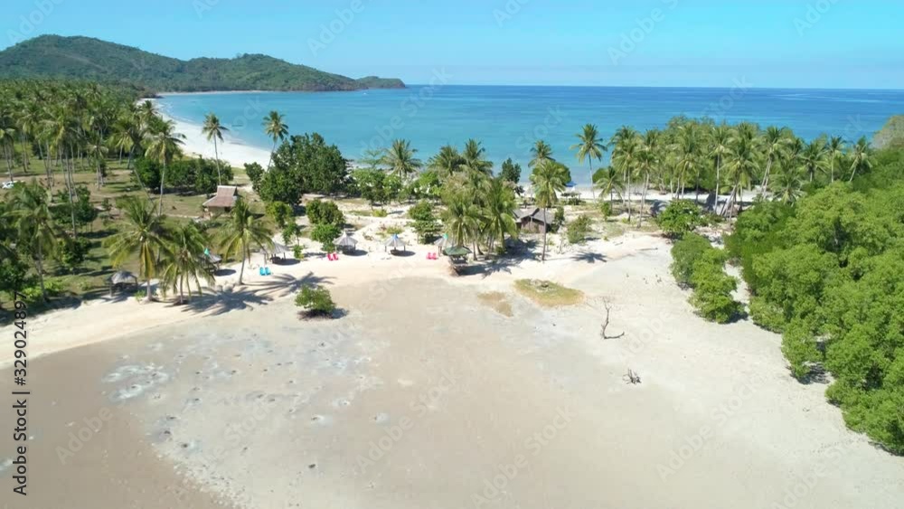 Aerial view of tropical sandy beach in bay with blue water. Seascape with sea, sand, palm trees. Top view of paradise island. Summer and travel vacation concept. Aerial view of tropical sandy beach in bay with blue water. Seascape with sea, sand, palm trees. Top view of paradise island. Summer and travel vacation concept.