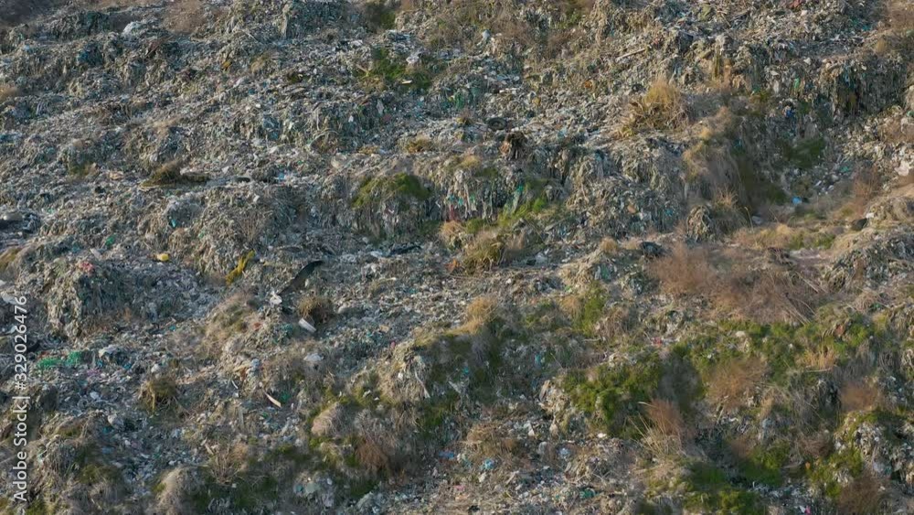 Aerial view of huge abandoned garbage dump. Landfill disposal site. Wastes of life and production. Environmental pollution. Aerial view of huge abandoned garbage dump. Landfill disposal site. Wastes of life and production. Environmental pollution.