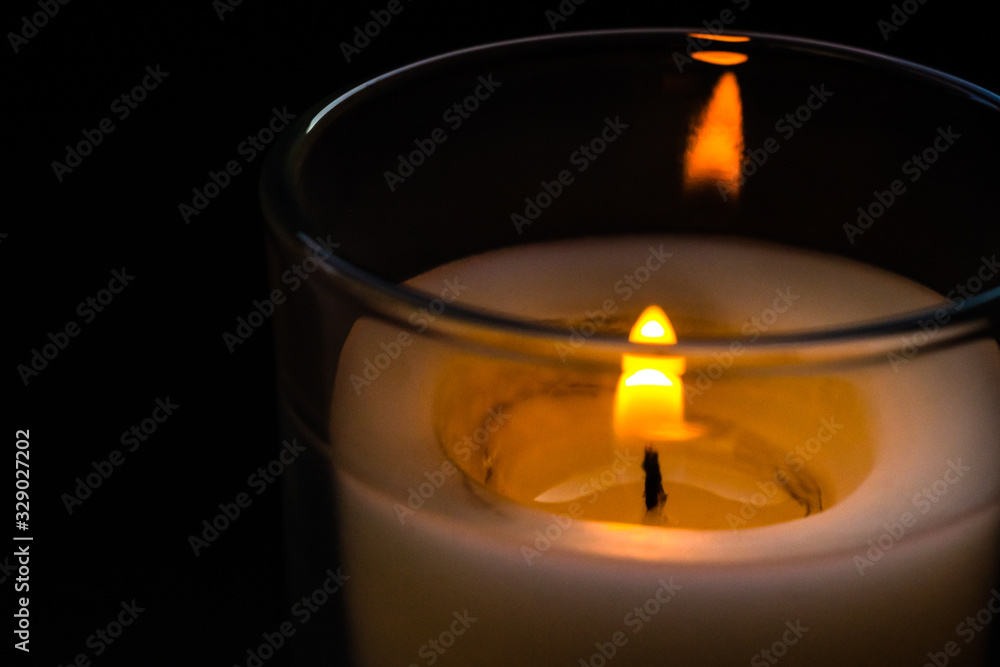 Candle in a glass jar. Sadness, remembrance and condolence concept Candle in a glass jar. Sadness, remembrance and condolence concept