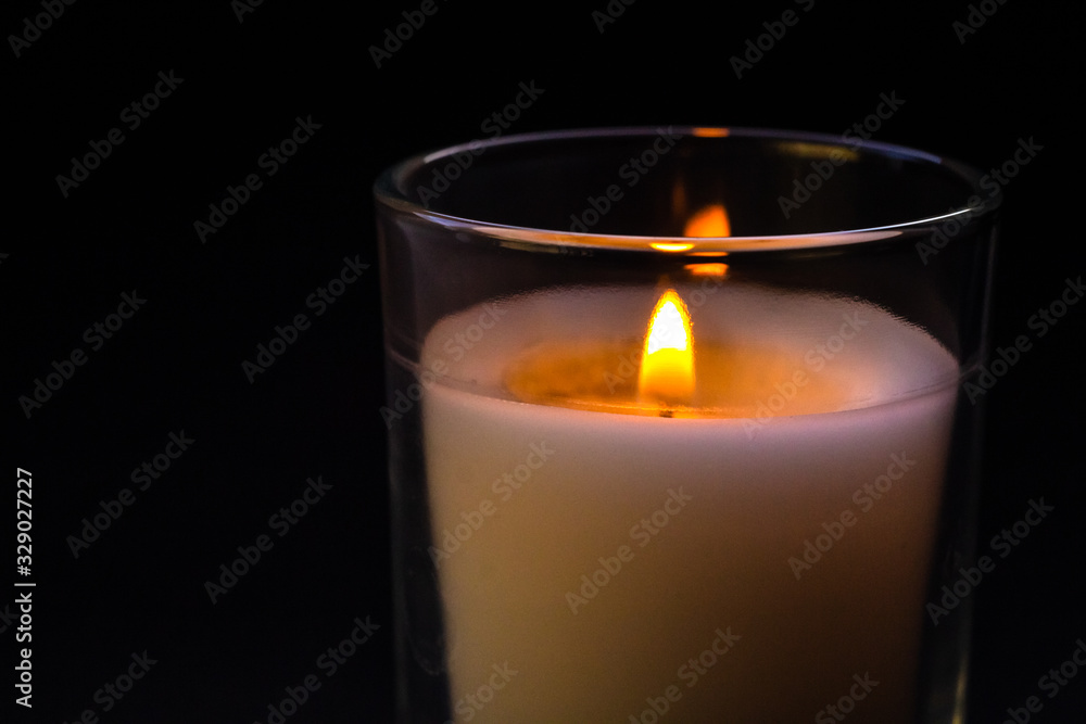 Candle in a glass jar. Sadness, remembrance and condolence concept Candle in a glass jar. Sadness, remembrance and condolence concept