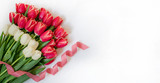 Easter or Valentine's day greeting card. Set of tulip with red ribbon on white background.