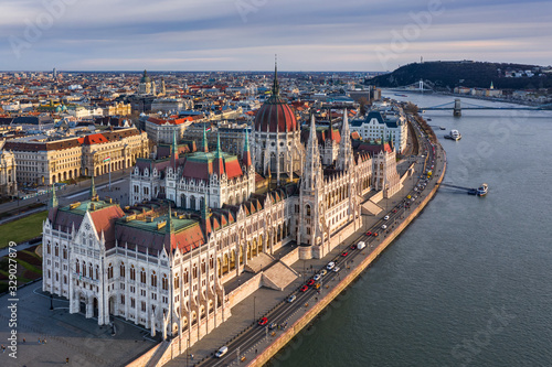 Photography Budapest, Hungary - Aerial view of the beautiful Hungarian Parliament building at sunset with warm colors and blue sky