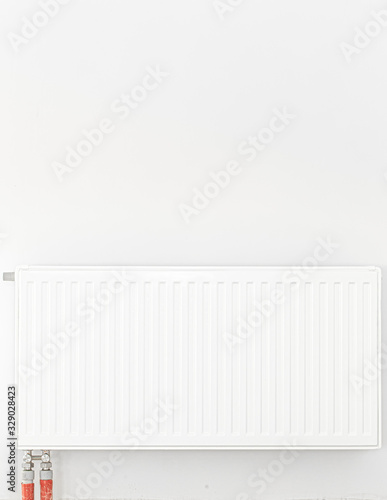 Radiator in front of a white wall. Space for text.