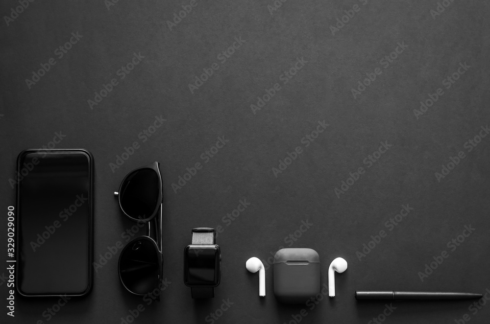 Men gadgets in modern lifestyle on dark background for minimalist flat lay black concept.. - obrazy, fototapety, plakaty 