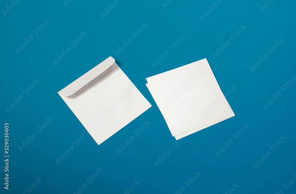 White envelope and post card on background. Top view blank envelope mockup and blank letterhead presentation template. Empty sheet for your design. White envelope and post card on background. Top view blank envelope mockup and blank letterhead presentation template. Empty sheet for your design.